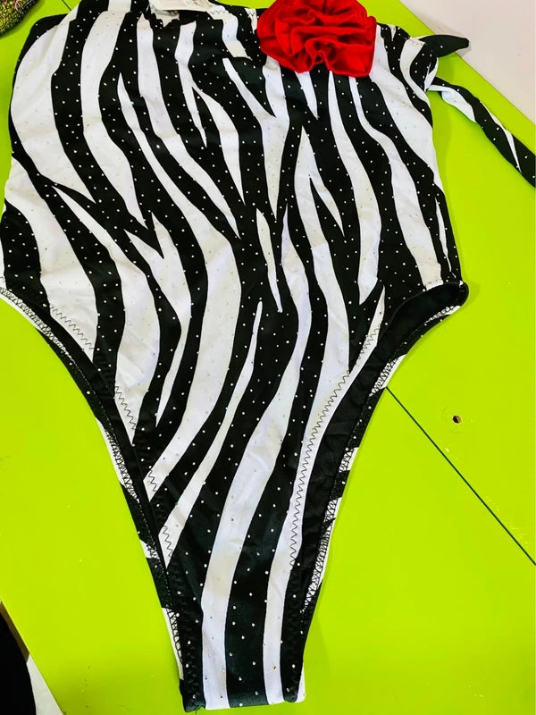 One-piece swimsuit and red skirt