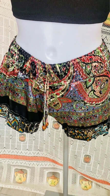 Boho chic outfit featuring colorful paisley shorts with an elastic waistband and drawstring detail.